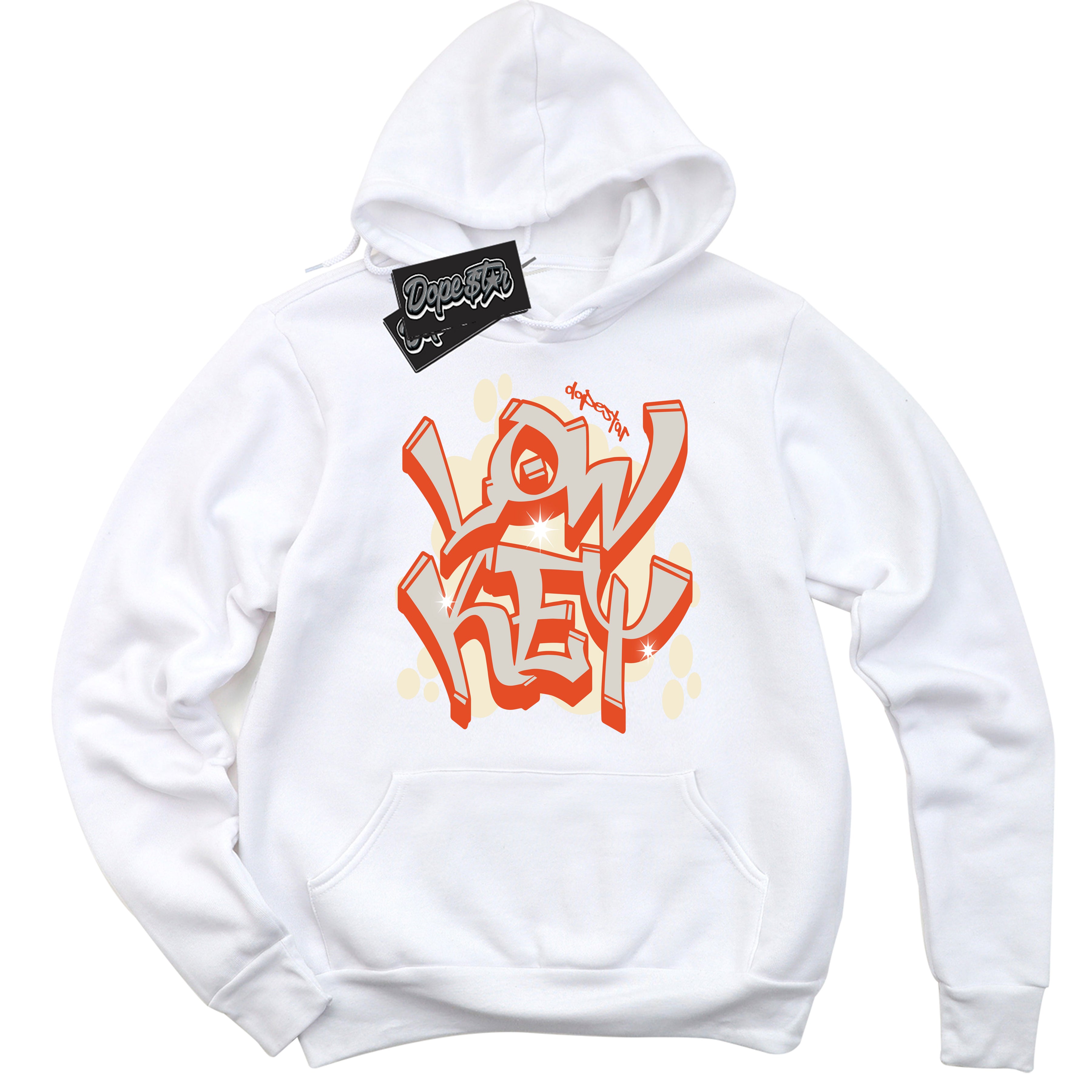 White “Low Key” Hoodie by Dope Star Brand®, styled to match Cinnabar 1s sneakers