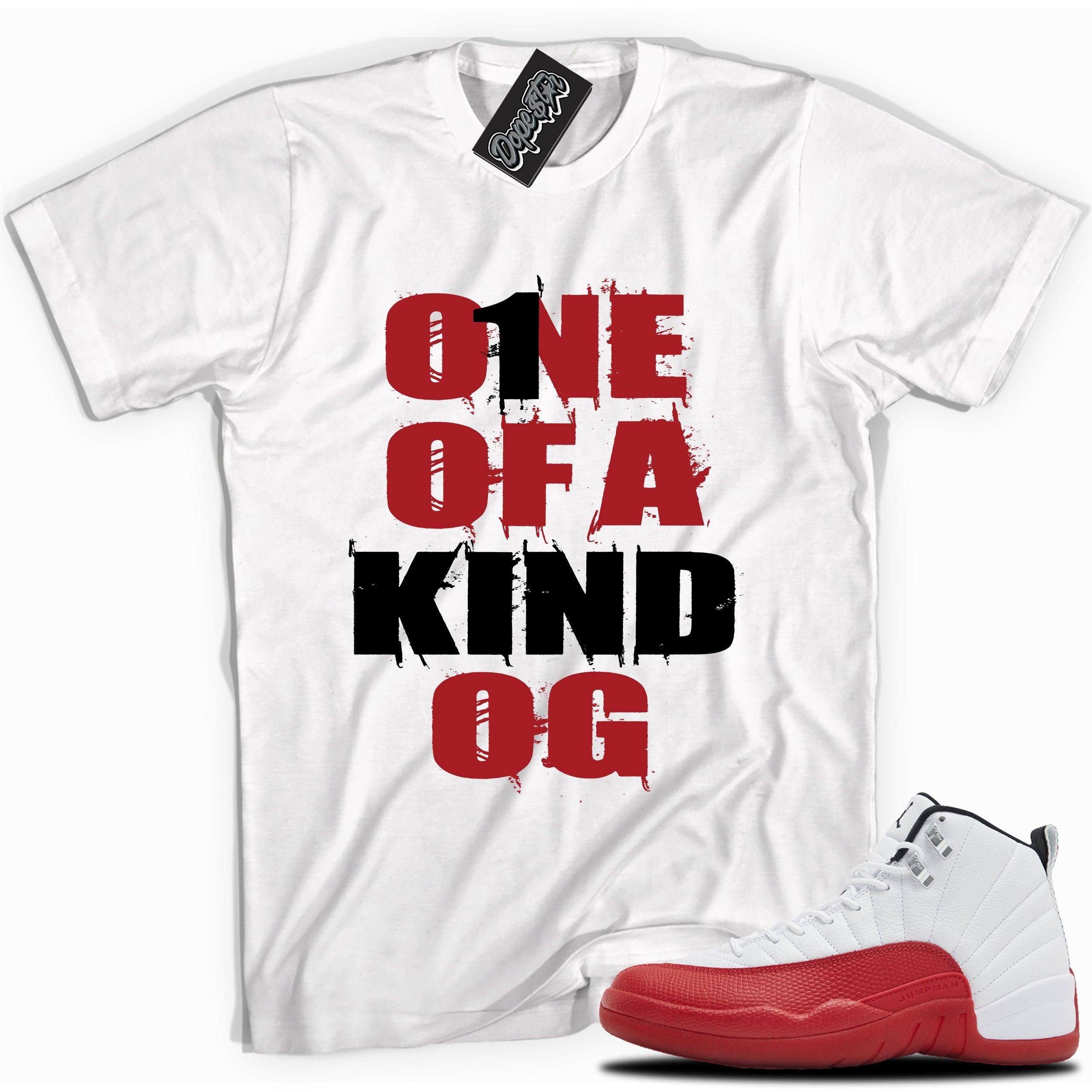 Cool White graphic tee with “ONE OF A KIND OG” print, that perfectly matches Air Jordan 12 Retro Cherry Red 2023 red and white sneakers