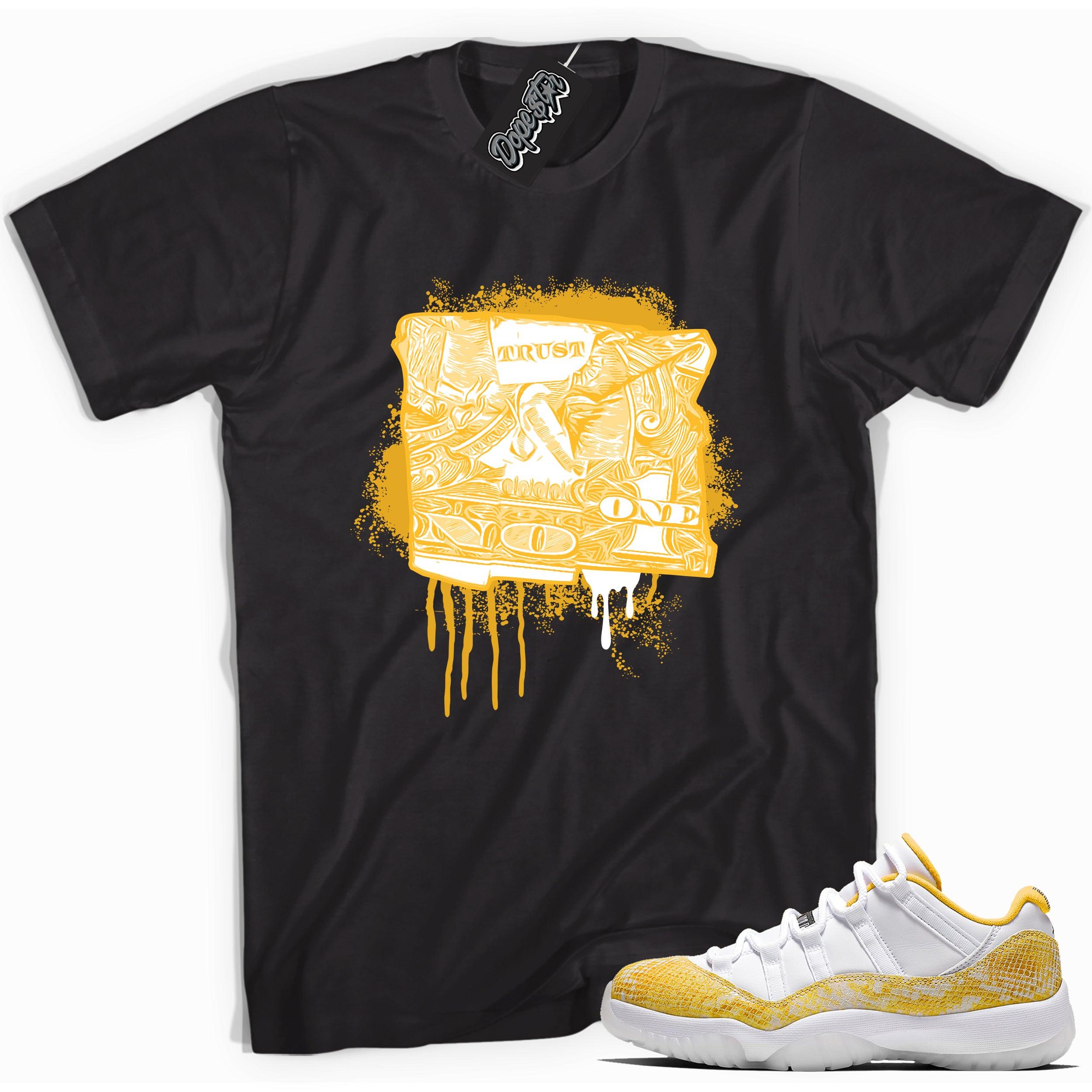 Cool black graphic tee with 'trust no one dollar bill' print, that perfectly matches  Air Jordan 11 Retro Low Yellow Snakeskin sneakers
