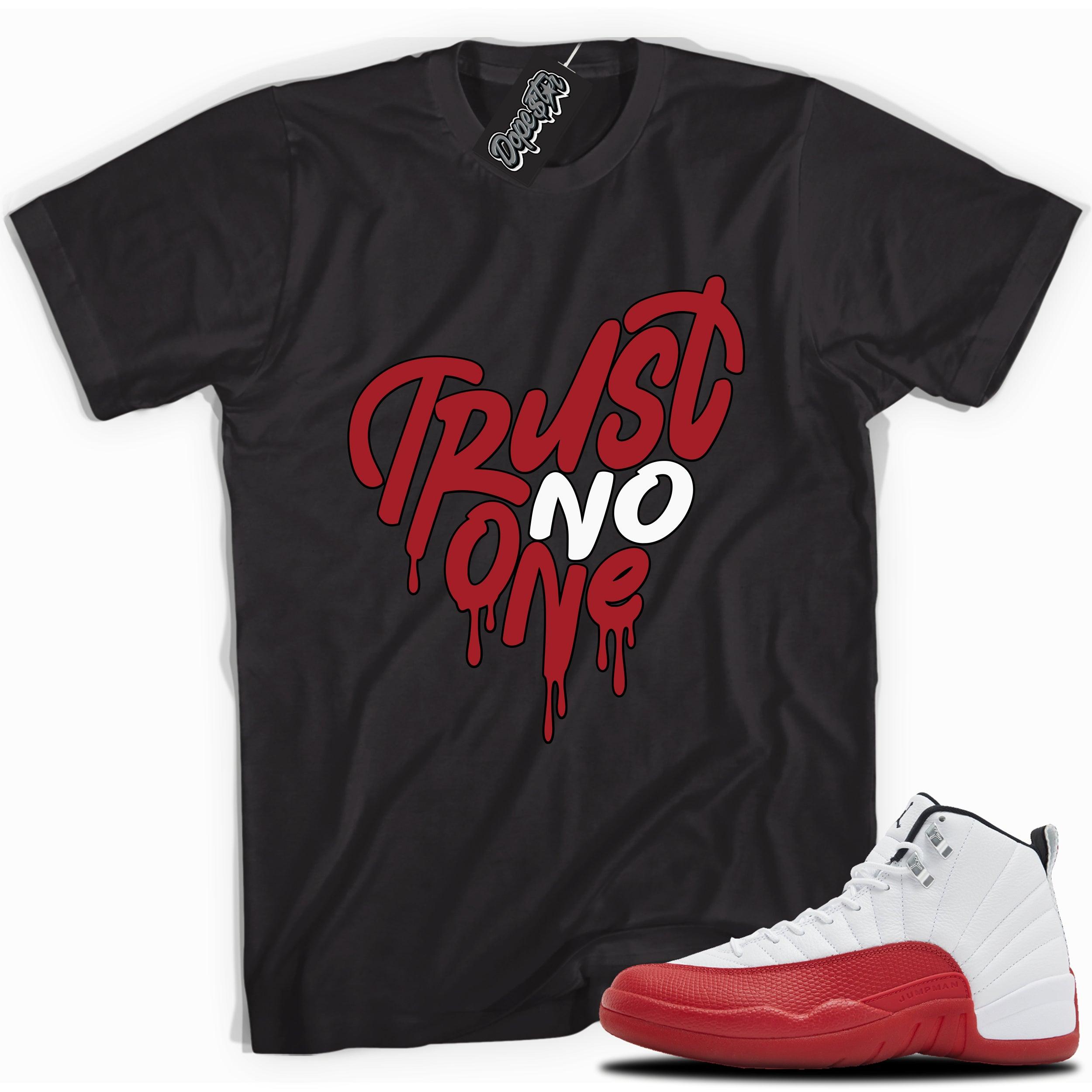 Cool black graphic tee with “Trust No One Heart” print, that perfectly matches Air Jordan 12 Retro Cherry Red 2023 red and white sneakers