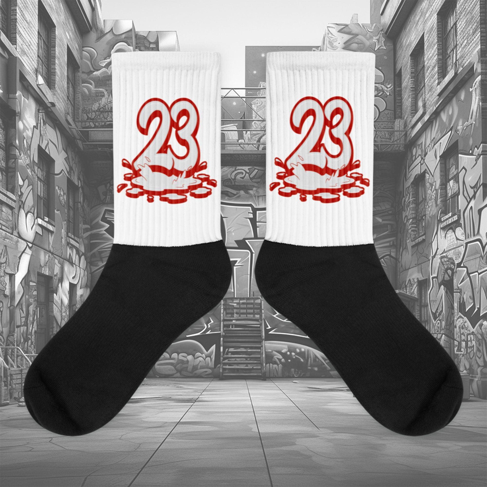 Showcases the view of the socks, highlighting the vibrant ' 23 Melting ' design, which perfectly complements the Air Jordan 11 Cherry sneakers. The intricate pattern and color scheme inspired by the  theme are prominently displayed.  Focusing on the ribbed leg , cusioned bottoms and the snug fit of the socks. This angle provides a clear view of the texture and quality of the material blend.