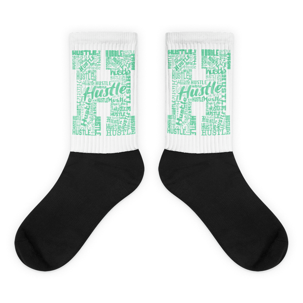 Showcases the view of the socks, highlighting the vibrant ' Hustle ' design, which perfectly complements the Nike Dunk Green Glow sneakers. The intricate pattern and color scheme inspired by the  theme are prominently displayed.  Focusing on the ribbed leg , cusioned bottoms and the snug fit of the socks. This angle provides a clear view of the texture and quality of the material blend.
