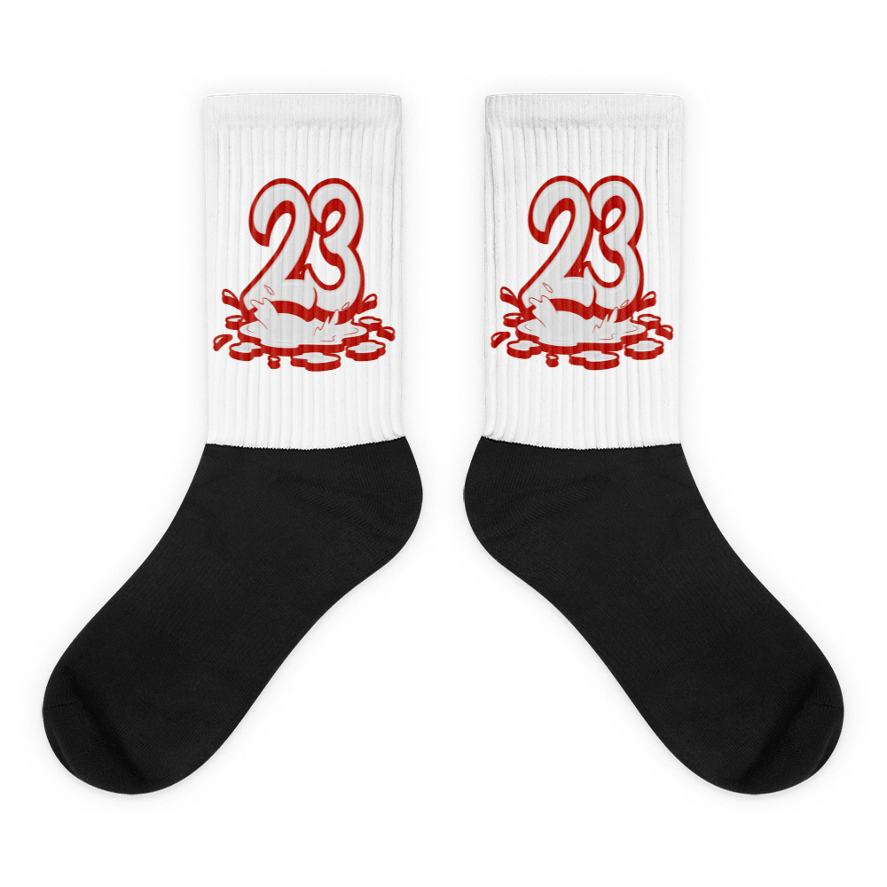 Showcases the view of the socks, highlighting the vibrant ' 23 Melting ' design, which perfectly complements the Air Jordan 11 Cherry sneakers. The intricate pattern and color scheme inspired by the  theme are prominently displayed.  Focusing on the ribbed leg , cusioned bottoms and the snug fit of the socks. This angle provides a clear view of the texture and quality of the material blend.