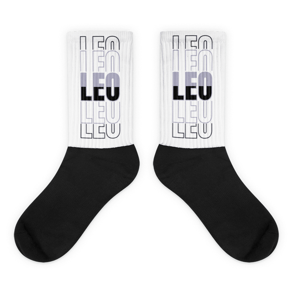 Showcases the view of the socks, highlighting the vibrant 'LEO' design, which perfectly complements the Air Jordan 8 Winterized  sneakers. The intricate pattern and color scheme inspired by the  theme are prominently displayed.  Focusing on the ribbed leg , cusioned bottoms and the snug fit of the socks. This angle provides a clear view of the texture and quality of the material blend.