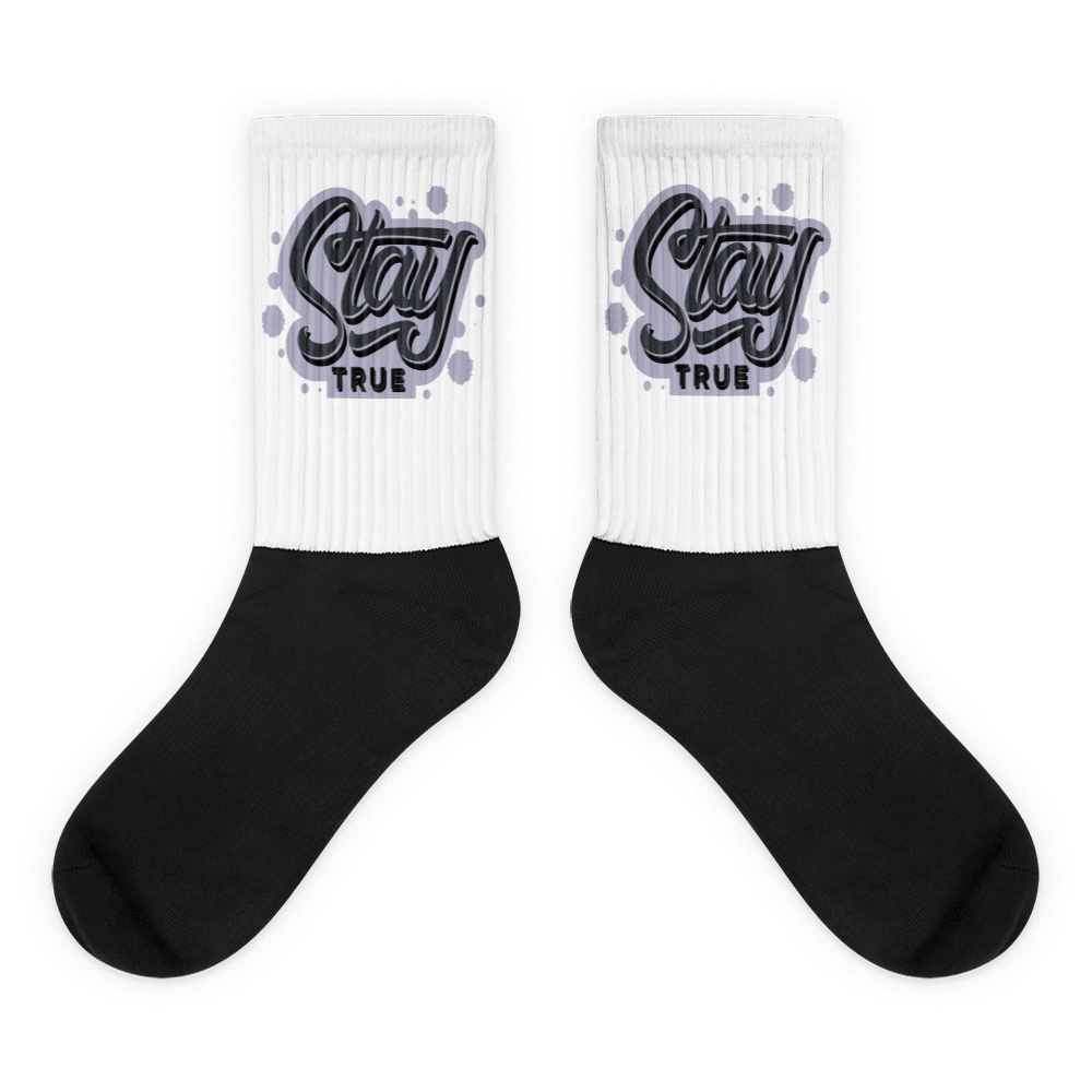 Showcases the view of the socks, highlighting the vibrant 'Stay True' design, which perfectly complements the Air Jordan 8 Winterized  sneakers. The intricate pattern and color scheme inspired by the  theme are prominently displayed.  Focusing on the ribbed leg , cusioned bottoms and the snug fit of the socks. This angle provides a clear view of the texture and quality of the material blend.