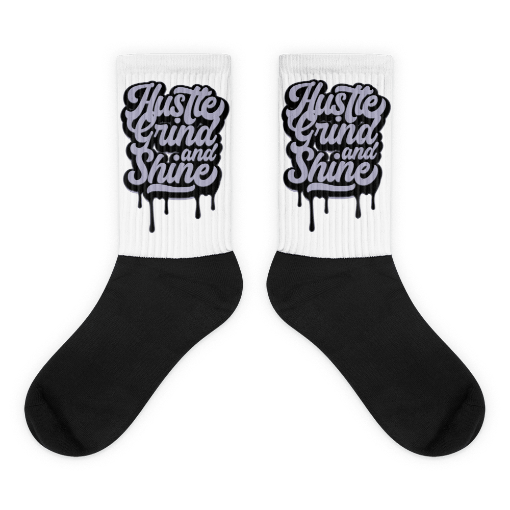 Showcases the view of the socks, highlighting the vibrant ‘Hustle Grind And Shine’ design, which perfectly complements the Air Jordan 8 Winterized  sneakers. The intricate pattern and color scheme inspired by the  theme are prominently displayed.  Focusing on the ribbed leg , cusioned bottoms and the snug fit of the socks. This angle provides a clear view of the texture and quality of the material blend.