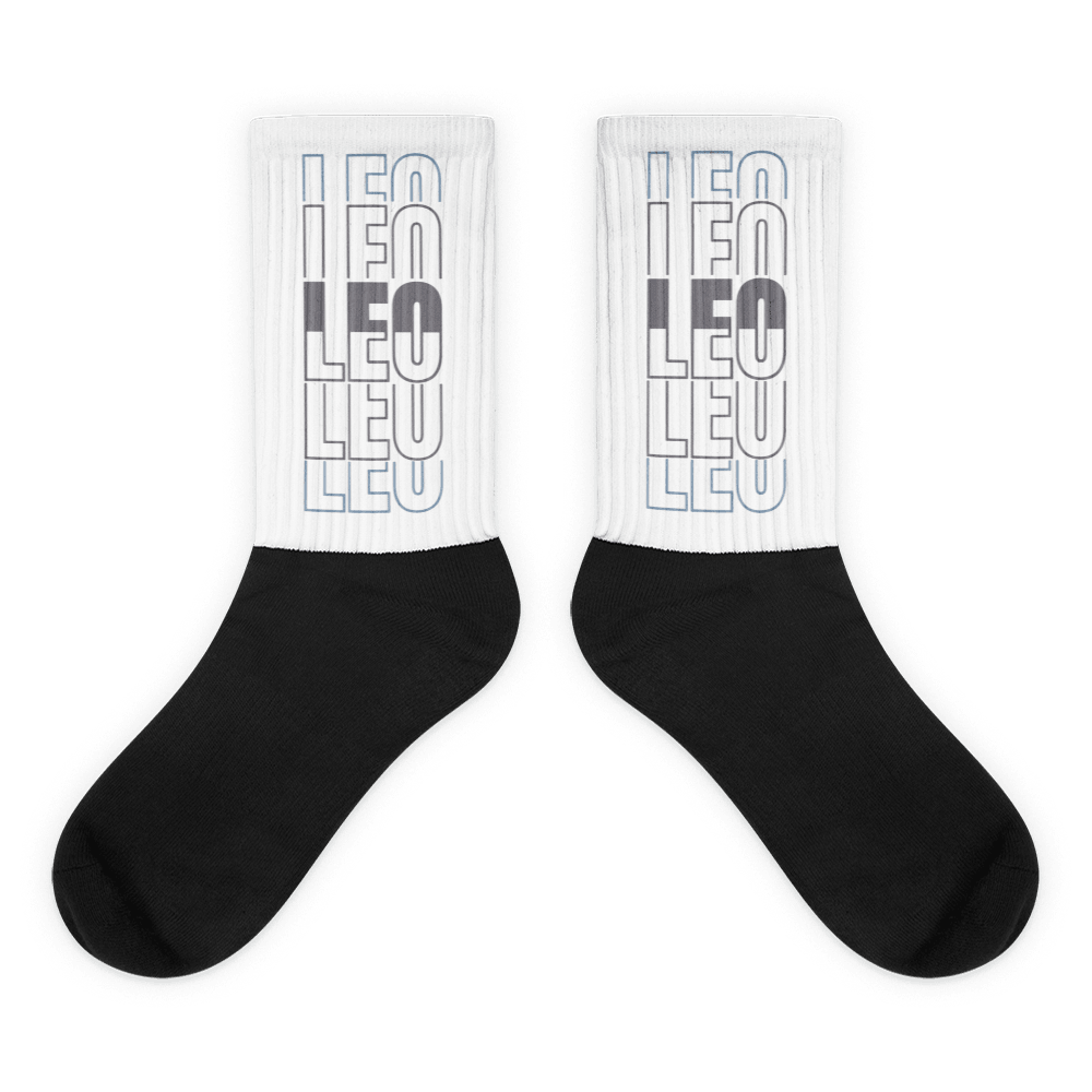 Showcases the view of the socks, highlighting the vibrant ‘LEO ‘ design, which perfectly complements the sneakers. The intricate pattern and color scheme inspired Air Jordan 11 Retro Low Cement Grey. Focusing on the ribbed leg , cusioned bottoms and the snug fit of the socks. This angle provides a clear view of the texture and quality of the material blend.