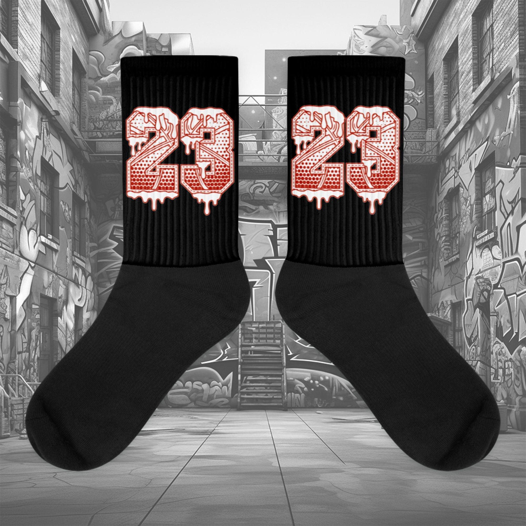 Showcases the view of the socks, highlighting the vibrant ' 23 Ball ' design, which perfectly complements the Air Jordan 11 Cherry sneakers. The intricate pattern and color scheme inspired by the  theme are prominently displayed.  Focusing on the ribbed leg , cusioned bottoms and the snug fit of the socks. This angle provides a clear view of the texture and quality of the material blend