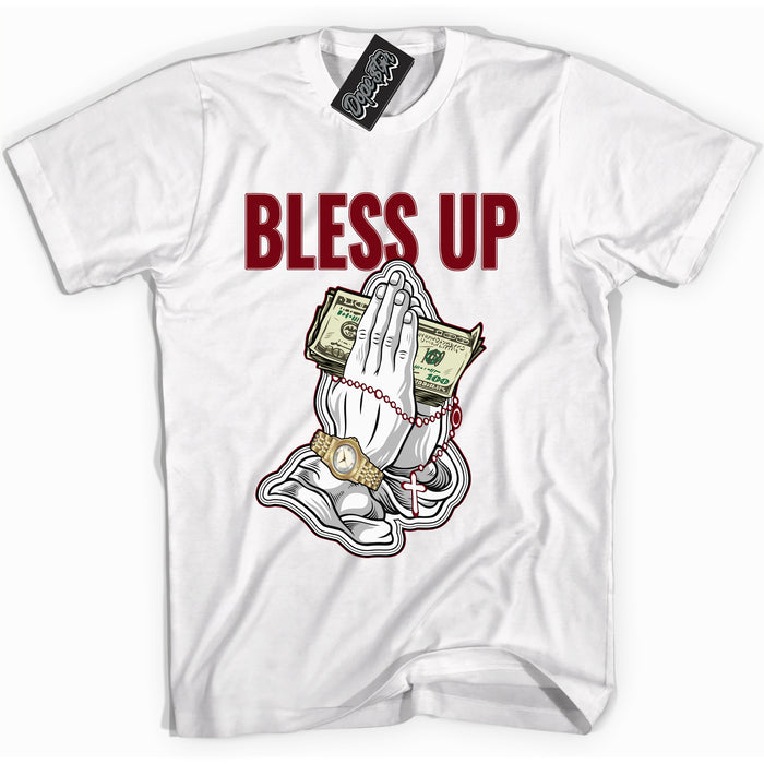 Cool White graphic tee with “ Bless Up ” print, that perfectly matches OG Metallic Burgundy 1s sneakers 