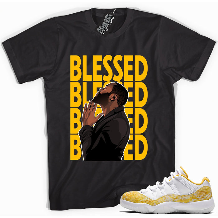 Cool black graphic tee with 'god blessed' print, that perfectly matches  Air Jordan 11 Low Yellow Snakeskin sneakers