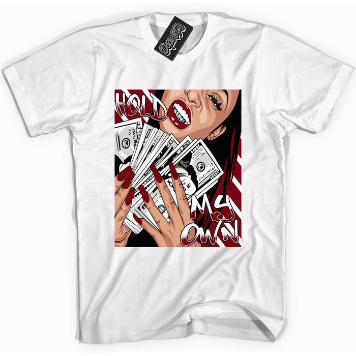 Cool White graphic tee with “ Hold My Own ” print, that perfectly matches OG Metallic Burgundy 1s sneakers 