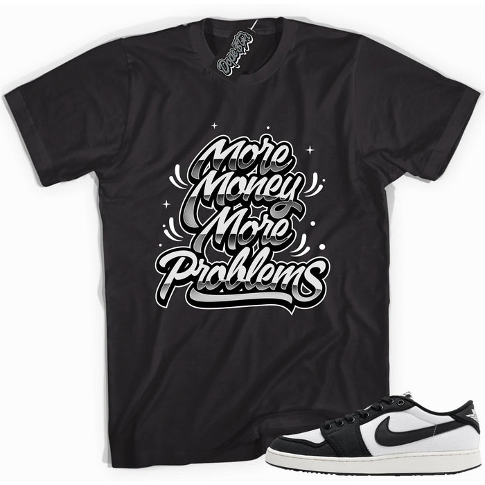 Cool black graphic tee with 'more money more problems' print, that perfectly matches Air Jordan 1 Retro Ajko Low Black & White sneakers.