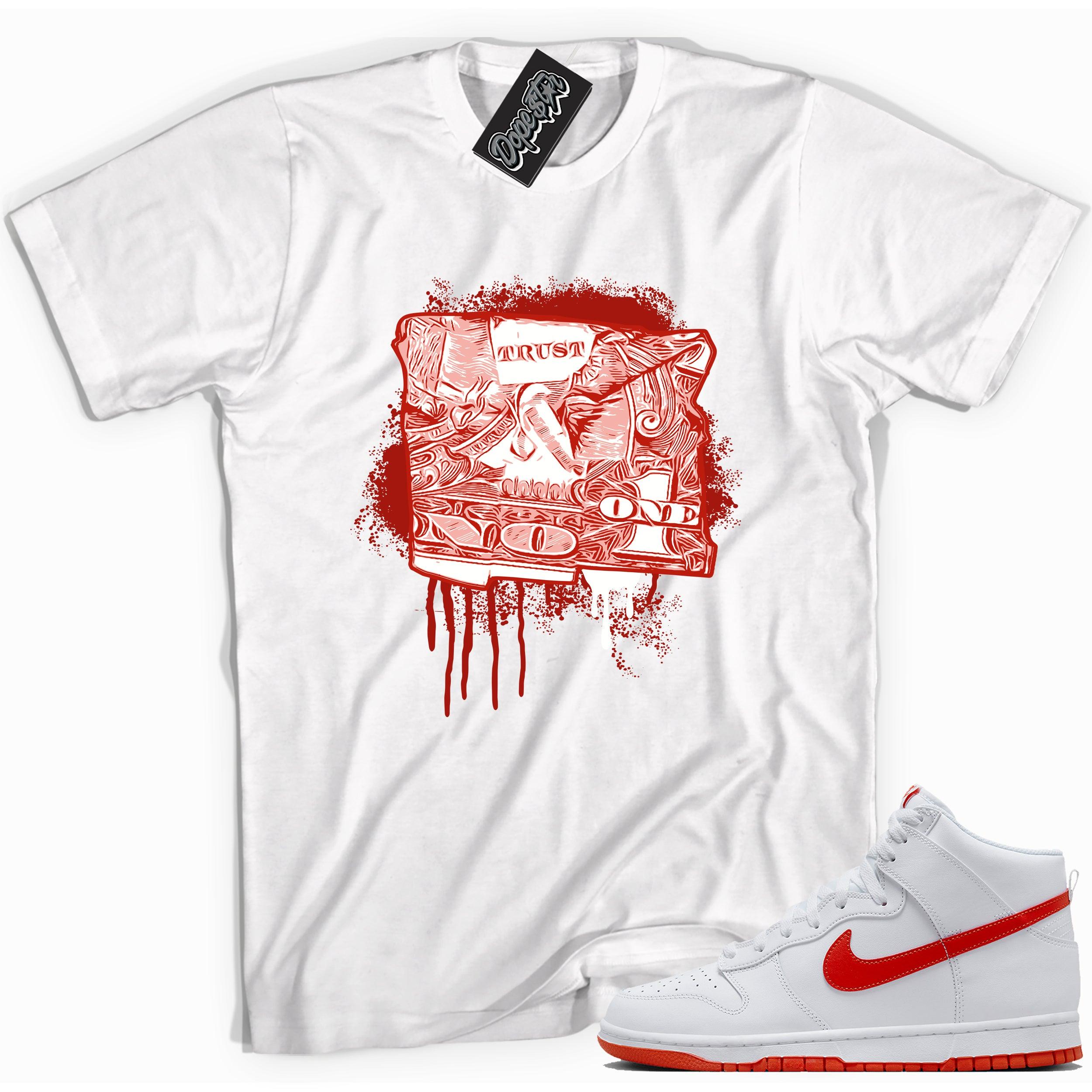 Cool white graphic tee with 'trust no one dollar bill' print, that perfectly matches Nike Dunk High White Picante Red sneakers.