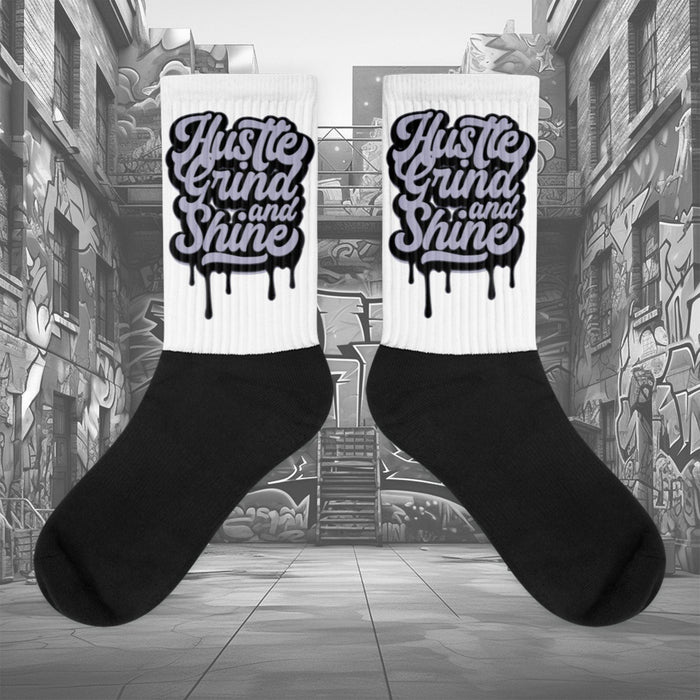  Showcases the view of the socks, highlighting the vibrant ‘Hustle Grind And Shine’ design, which perfectly complements the Air Jordan 8 Winterized  sneakers. The intricate pattern and color scheme inspired by the  theme are prominently displayed.  Focusing on the ribbed leg , cusioned bottoms and the snug fit of the socks. This angle provides a clear view of the texture and quality of the material blend.