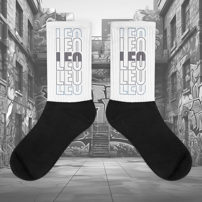 Showcases the view of the socks, highlighting the vibrant ‘LEO ‘ design, which perfectly complements the sneakers. The intricate pattern and color scheme inspired Air Jordan 11 Retro Low Cement Grey.  Focusing on the ribbed leg , cusioned bottoms and the snug fit of the socks. This angle provides a clear view of the texture and quality of the material blend.