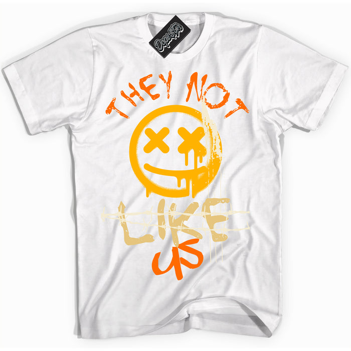White “They Not Like Us” T-shirt by Dope Star Brand®, styled to match Saturn Gold Dunk sneakers